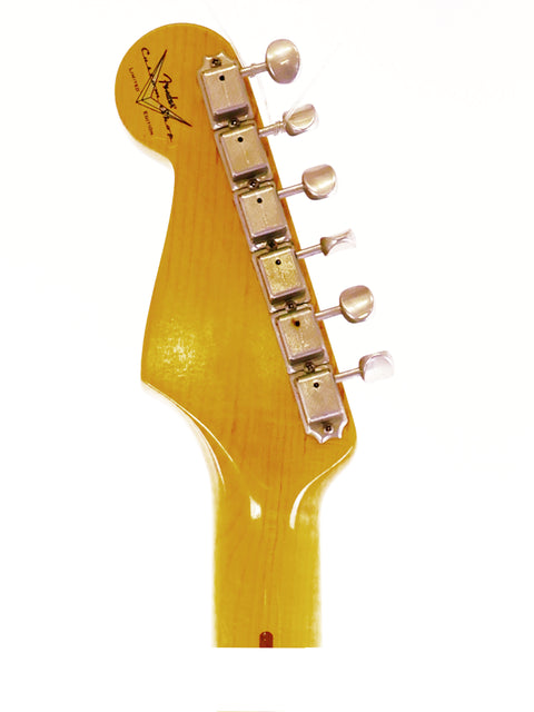 Close-up image of a guitar head featuring a yellow body, specifically a Fender Ltd Custom 50s Journeyman Stratocaster from 2018.