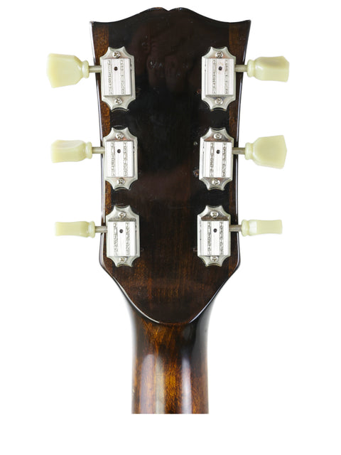 Close-up of a 1970s Gibson ES-175D acoustic guitar headstock showcasing four tuning knobs for enhanced playability.