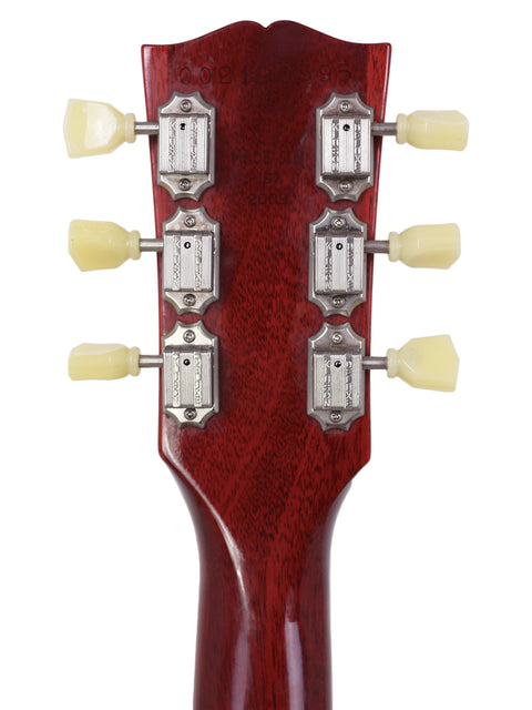 Close-up of a 2009 Gibson Les Paul Traditional headstock, showcasing four knobs for volume and tone control on the electric guitar.