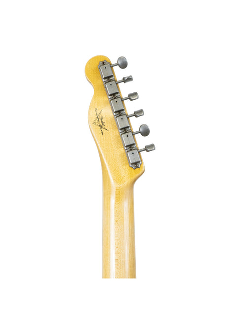 Close-up of a Fender Custom Shop 60s Journeyman Telecaster guitar head with a vibrant yellow body.