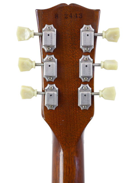 Close-up of a Gibson Les Paul Classic 1960 Reissue headstock, highlighting four tuning knobs and elegant craftsmanship.
