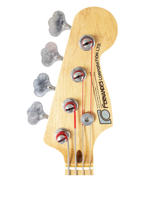 Close-up of a four-string bass head with a red dot, showcasing a Fernandes P Bass crafted in Japan from 1978 to 1981.
