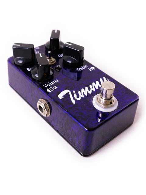 Close-up of a purple guitar pedal labeled 'Timmy' by Paul Cochrane, showcasing a sleek black control knob.
