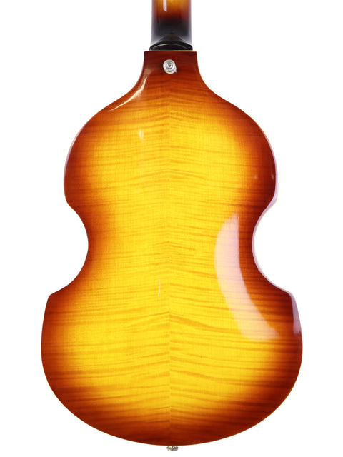 Close-up of the back of a sunburst patterned acoustic guitar.