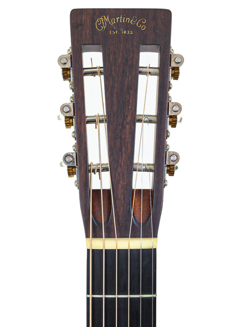 Close-up of the headstock from a 2014 Martin 00-28VS acoustic guitar, highlighting its classic features and quality.