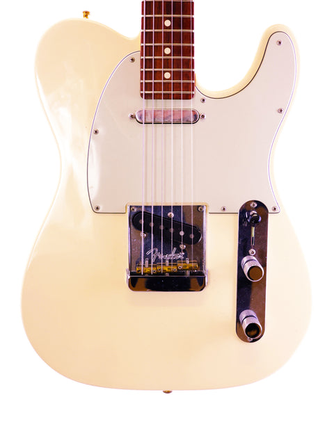 Cream-colored electric guitar body with pickguard and strings visible.
