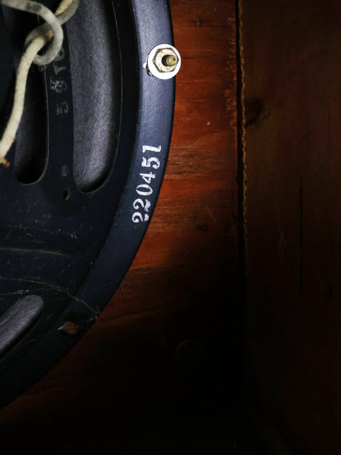 Detailed view of a 1955 Fender Tweed Deluxe Amp 5D3 speaker, featuring a prominent number displayed on its surface.