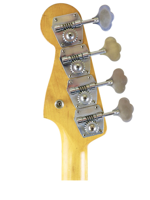 Detailed view of a 1972 Fender Precision Bass guitar head with four knobs, highlighting its vintage craftsmanship.