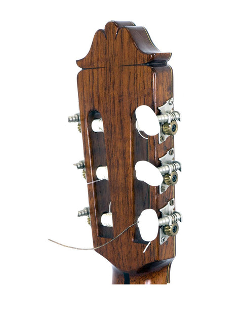 Detailed view of a 1976 Nakade Master 30 Grand Concert Guitar headstock, highlighting four strings and vintage aesthetics.