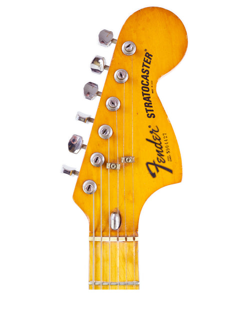 Detailed view of a 1979 USA Fender Stratocaster guitar head featuring a vibrant yellow body.