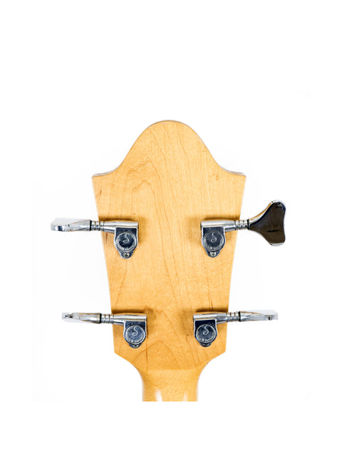 Detailed view of a 1980s Ernie Ball Earthwood Bass guitar head with four strings, highlighting its classic style and quality.