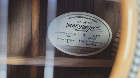 Detailed view of a guitar featuring a label that reads Breedlove Journey Concert Ltd Sitka / Brazilian #22 of 50, USA 2016.