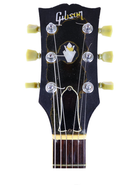 Detailed view of a yellow headstock from a Gibson SG '61 Reissue guitar, made in the USA in 1988, highlighting its vintage appeal.