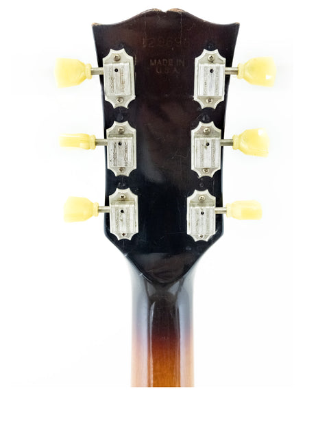 Detailed view of the headstock of a 1973 vintage Gibson Les Paul Standard guitar, highlighting its iconic features.