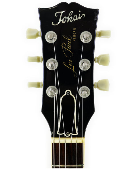 Detailed view of the headstock of a 1979 Tokai Les Paul Reborn LS50 guitar, highlighting its classic features and finish.