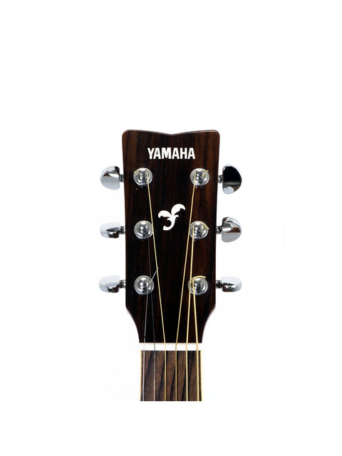 Detailed view of the headstock of a 2012 Yamaha FG 720 SL left-handed acoustic guitar, highlighting its craftsmanship and style.