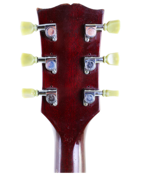 Detailed view of the headstock of a Gibson SG '61 Reissue electric guitar, highlighting its classic features from 1988.