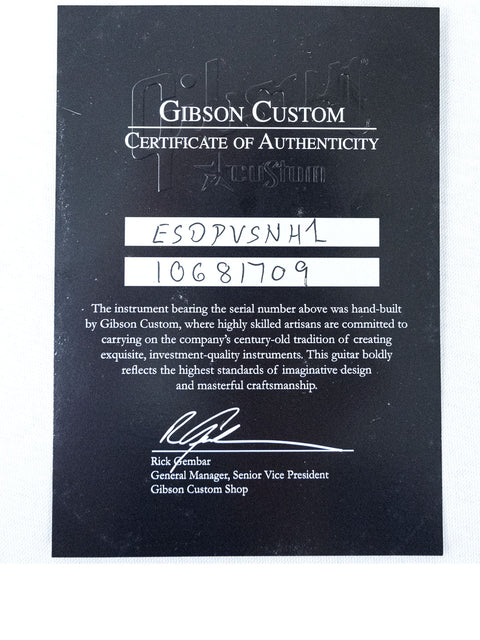 Display of a certificate for the Gibson Custom ES-335 Dot Inlay, USA 2012, emphasizing its craftsmanship and authenticity.