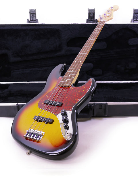Fender Jazz Bass guitar in a case, set against a clean white background, showcasing its sleek design and craftsmanship.
