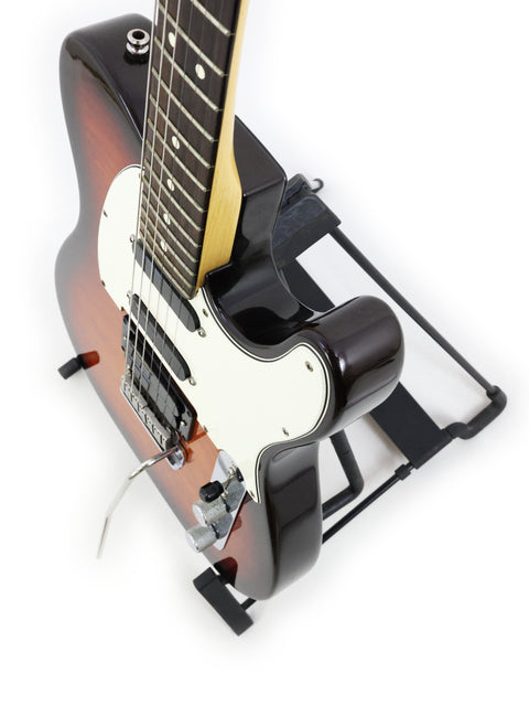 Fender Telecaster Plus Deluxe guitar from 1992, resting on a stand, showcasing its classic design and craftsmanship.