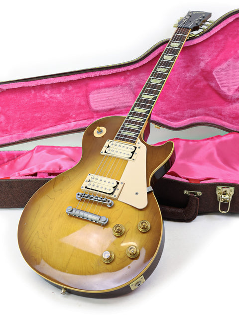 Gibson Les Paul Classic 1960 Reissue guitar in a pink case, showcasing its elegant design and vibrant color.