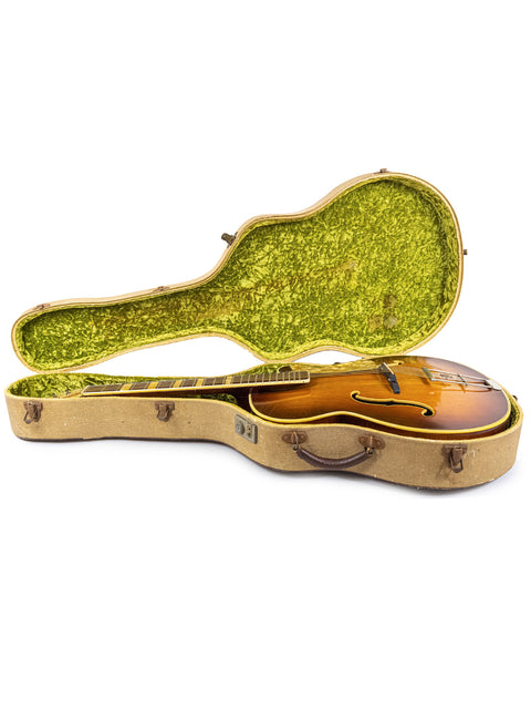 Green-covered guitar case with a brown body, representing the vintage Hofner 455 Archtop from Germany in the 1950s.