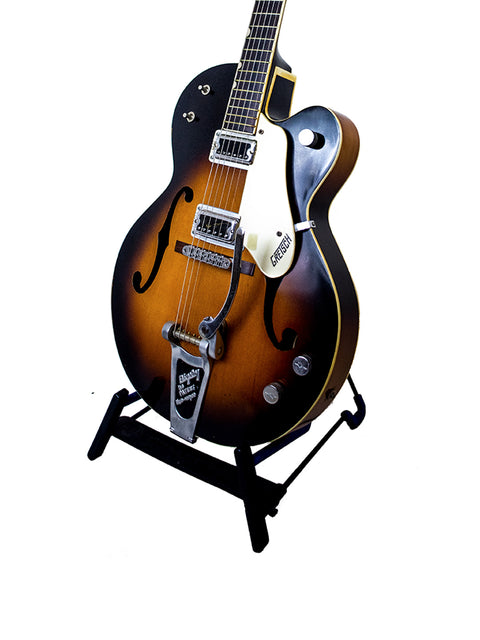 Gretsch G-60 guitar stand featuring a 1964 Double Anniversary 6117, emphasizing the vintage style and iconic design.