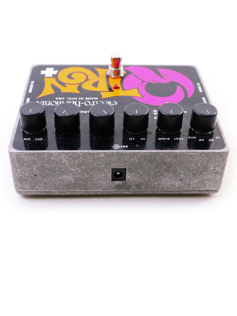 Guitar pedal with knobs and a psychedelic graphic on a white background.
