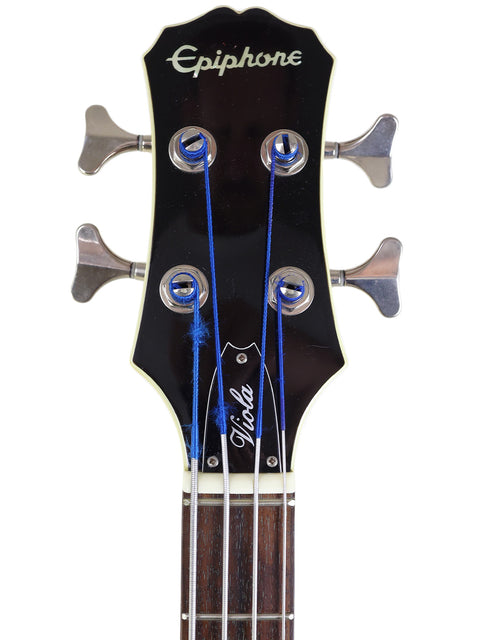 Headstock of an Epiphone guitar with tuning pegs and blue strings.