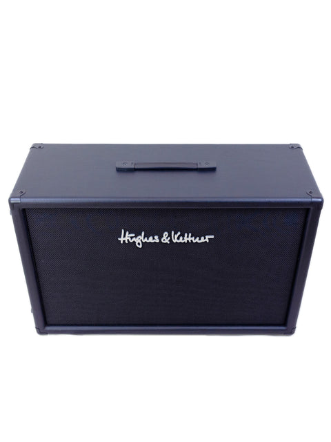  Hohner harmonica collection displayed with a Hughes & Kettner TM 212 speaker box in a vibrant setting.
