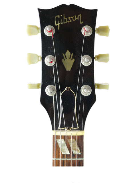 Iconic Gibson Les Paul Custom '59 guitar displayed with a vintage Gibson ES-175D from the 1970s, showcasing musical heritage.
