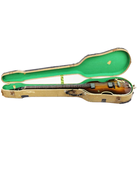 Inside a green and brown guitar case lies a Hofner 500/1 'Beatle Bass' from Germany, crafted in 1962.