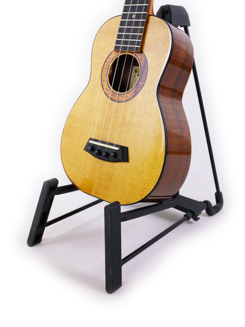 A Kanile’a Platinum Limited Edition Super Concert Ukulele from Hawaii 2017 displayed elegantly on a stand.