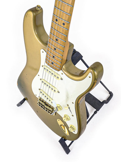 Limited Edition '57 Fender Custom Shop Stratocaster in gold with a black pick guard, crafted in the USA, 1988.