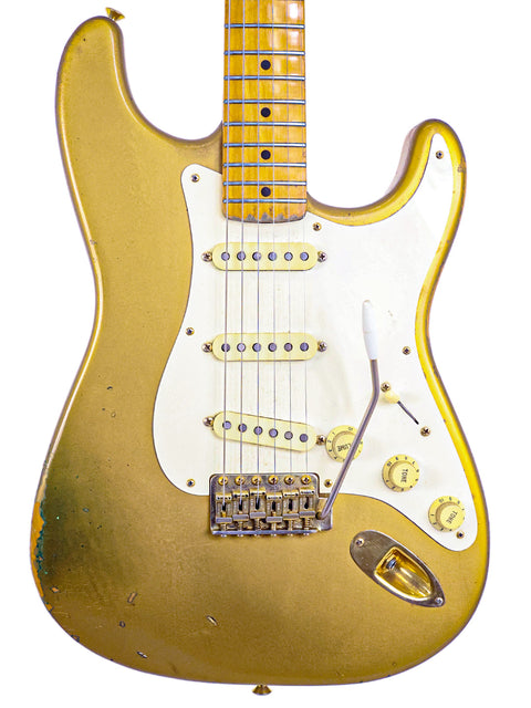 Limited edition gold Fender Stratocaster guitar featuring a white pickguard, designed by Homer Haynes, USA 1988.
