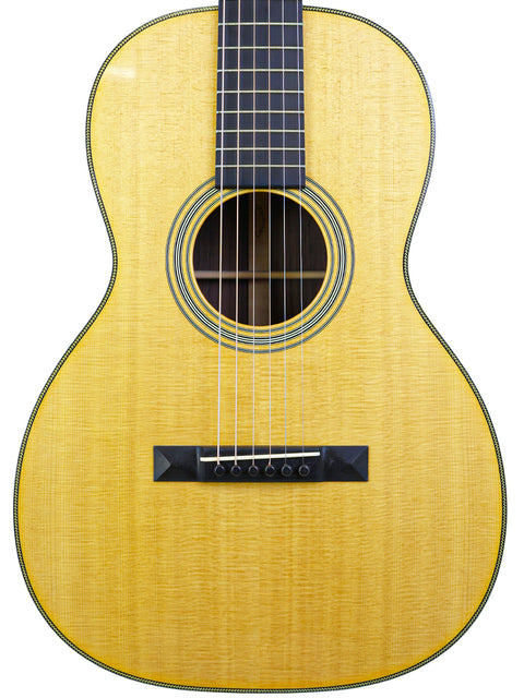 Martin 00-28VS guitar from 2014, showcasing a wooden top and black pick, representing quality American craftsmanship.