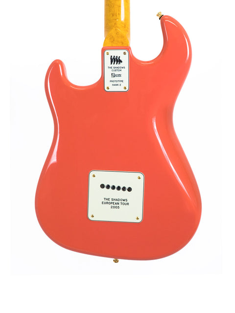 Red electric guitar back with "The Shadows" tour plaque.