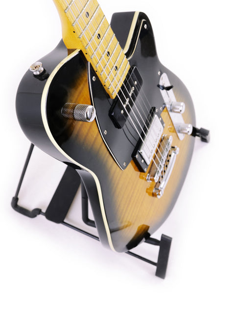 Reverend Double Agent guitar from Korea, 2016, featuring a black body and yellow neck, elegantly positioned on a stand.
