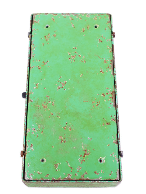 Rustic green metal box, inspired by the Trueman 1966 Fuzz Pedal, reflecting its unique design from Russia in 2021.