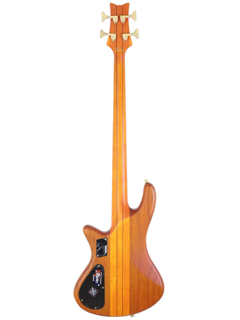 Schecter Stiletto Studio 4 bass guitar featuring a sleek wooden body and neck, showcasing craftsmanship from South Korea.