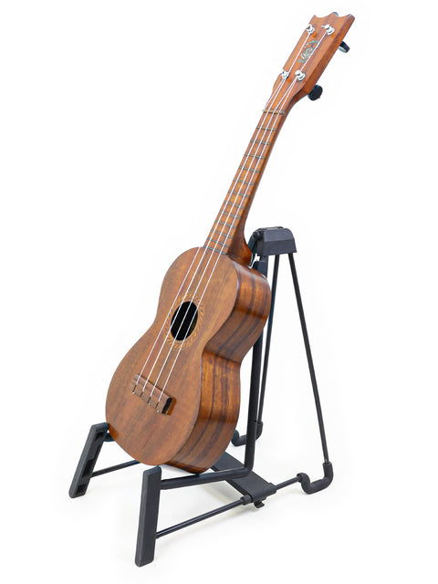 Side-angle view of the Aloha/Akai Style 2 Concert Ukulele placed on a stand, displaying its elegant curves and vintage aesthetic.