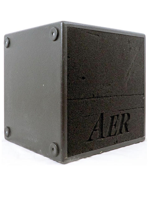 Side view of the AER Bass Cube 2 amplifier highlighting its compact design and rugged black finish.