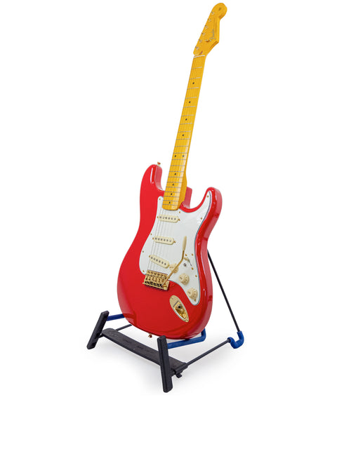 StrXX Partscaster – USA 2012: a striking red electric guitar displayed on a stand, ready for a jam session.
