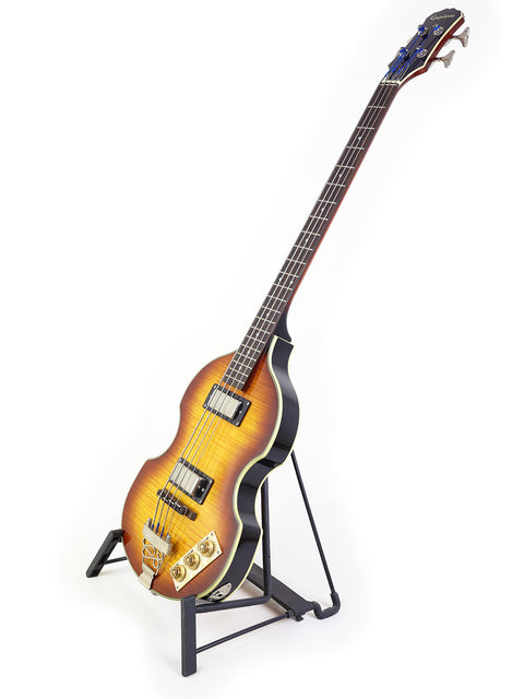 Sunburst electric guitar on a stand against a white background.