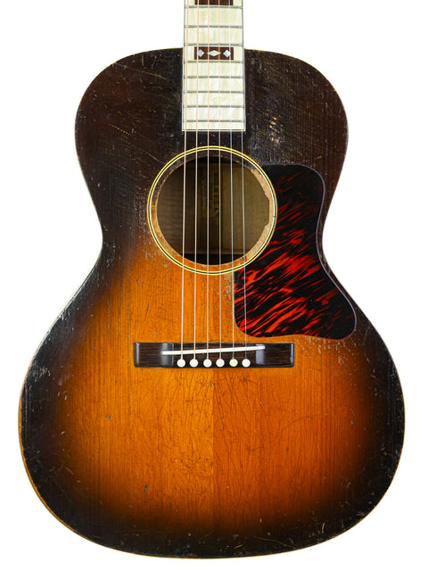The 1930 Gibson J-45 sunburst guitar, a symbol of vintage craftsmanship, reflecting its rich musical heritage.
