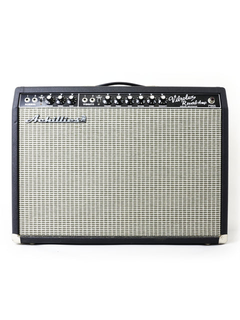 The 2021 Achillies Vibrolux Reverb Combo Amp is prominently featured against a white backdrop, highlighting its stylish appearance.