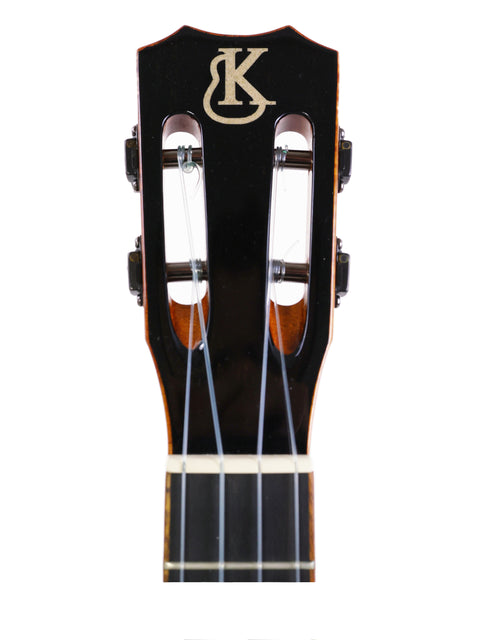 The Kanile’a Platinum Limited Edition Super Concert Ukulele, featuring a glossy finish and detailed inlays, displayed elegantly.