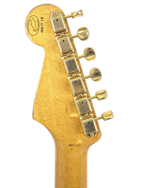 The headstock of a 1988 HLE ’57 Fender Custom Shop Stratocaster, featuring gleaming gold hardware and vintage charm.