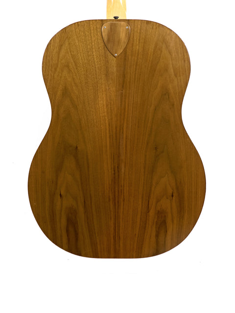 The wooden back of an Ernie Ball Earthwood Bass guitar from the 1980s, highlighting its classic acoustic craftsmanship.