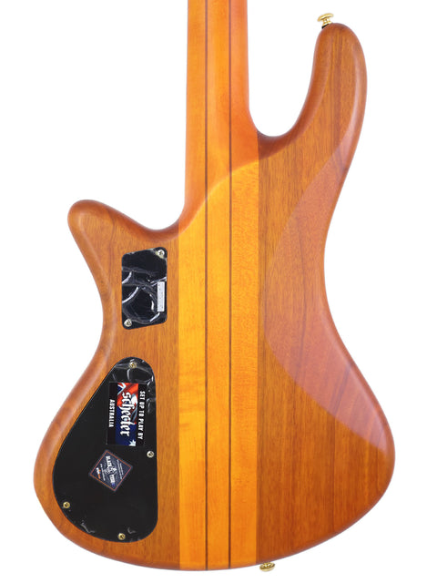 This Schecter Stiletto Studio 4 bass guitar features a beautifully crafted wooden body paired with a striking black pickguard.